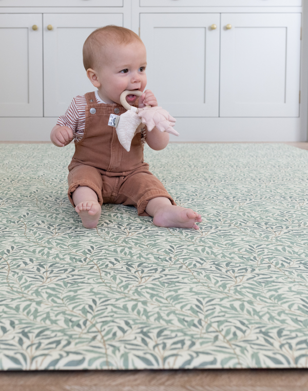 baby teething toy on totter and tumble playmat in collaboration with Morris & co. in heritage willow boughs print one piece playmat for toddlers
