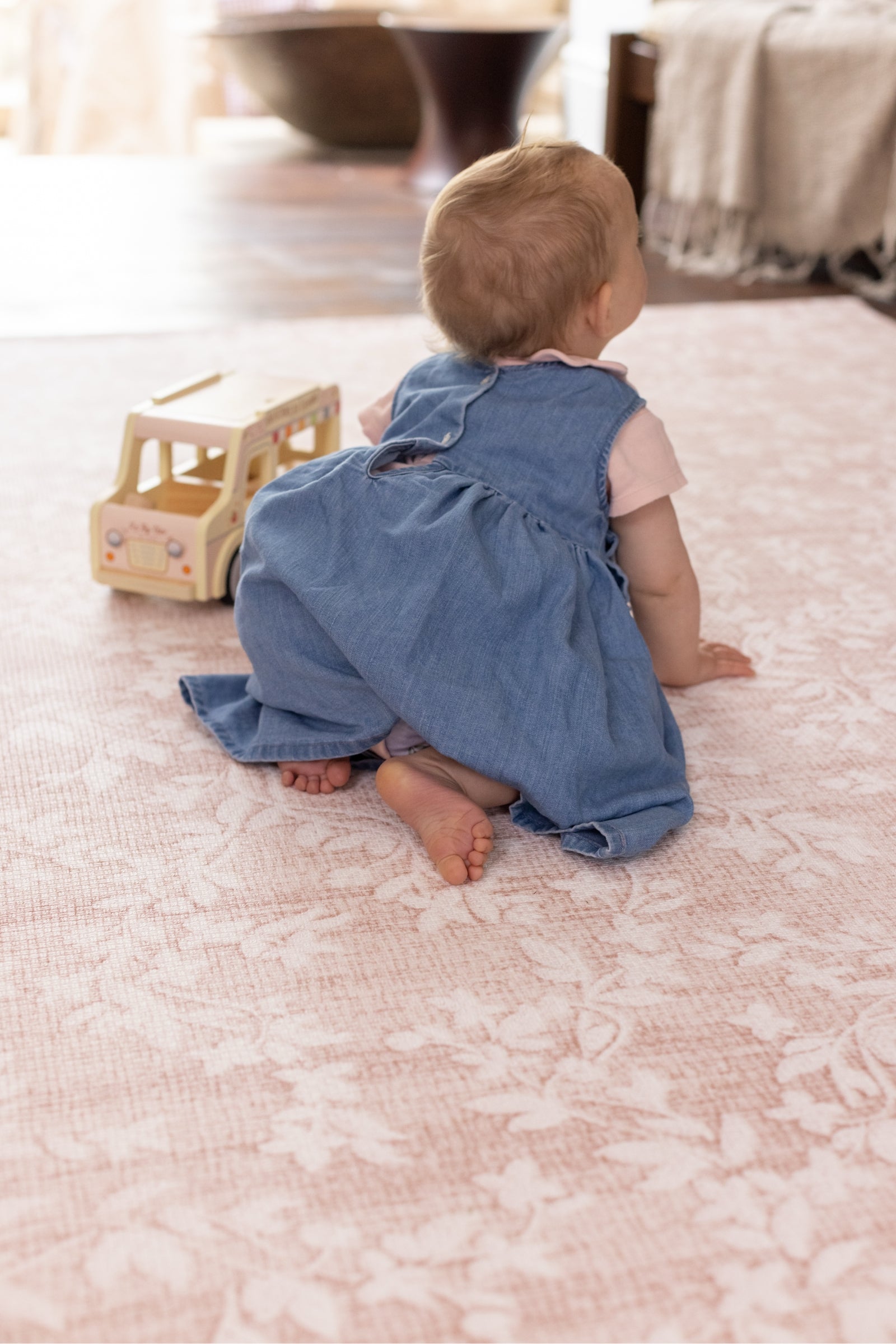 Baby crawling on the pink aster playmat from totter and tumble