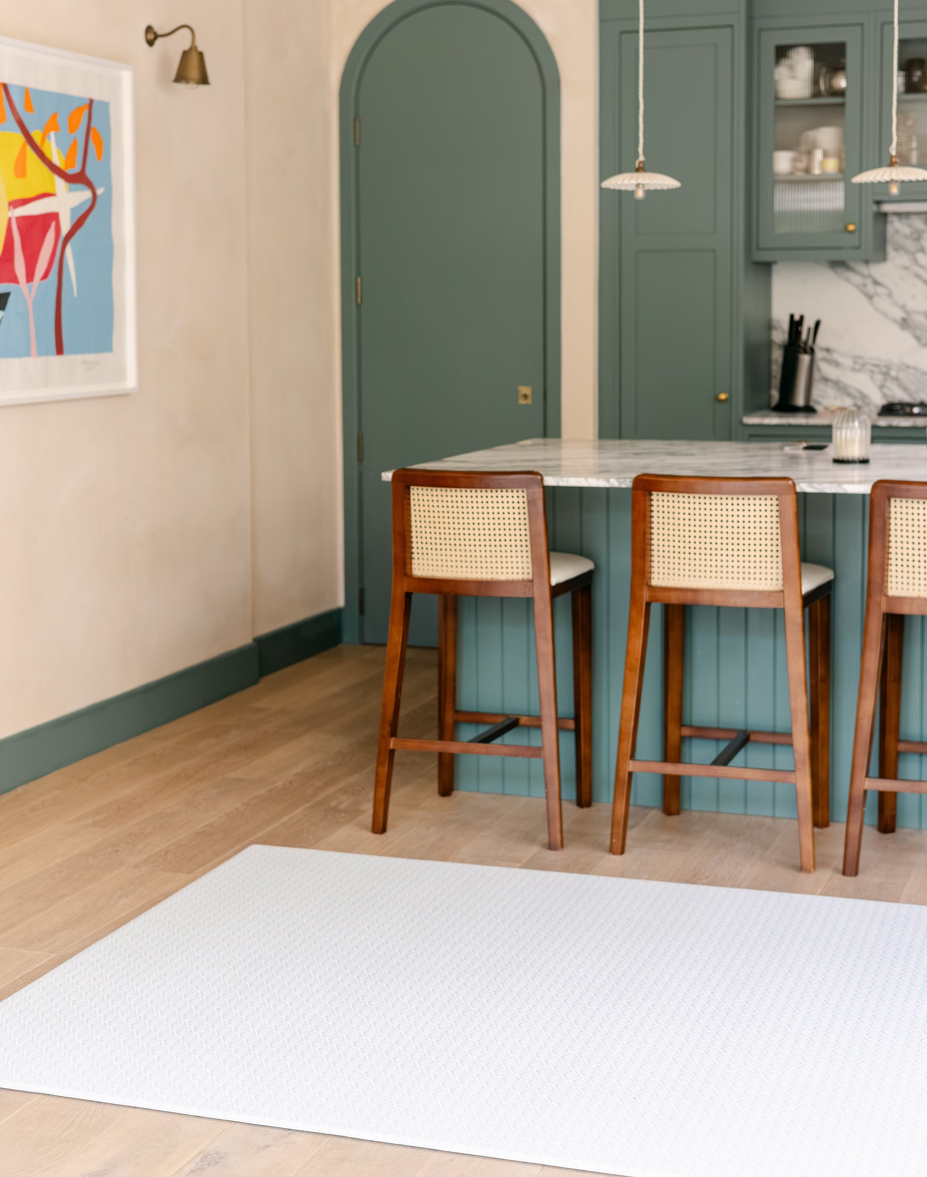 The beachcomber coastal inspired shell design playmat from totter and tumble shown in a kitchen dining room