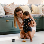 A woman helping her baby take some steps safely and comfortably on the totter and tumble playmat