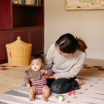 Mum and baby on The Counter, Totter + Tumble wipeable and reversible memory foam playmat