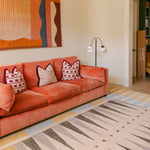 Colourful sofa and interiors with The Counter, Totter + Tumble wipeable and reversible memory foam playmat