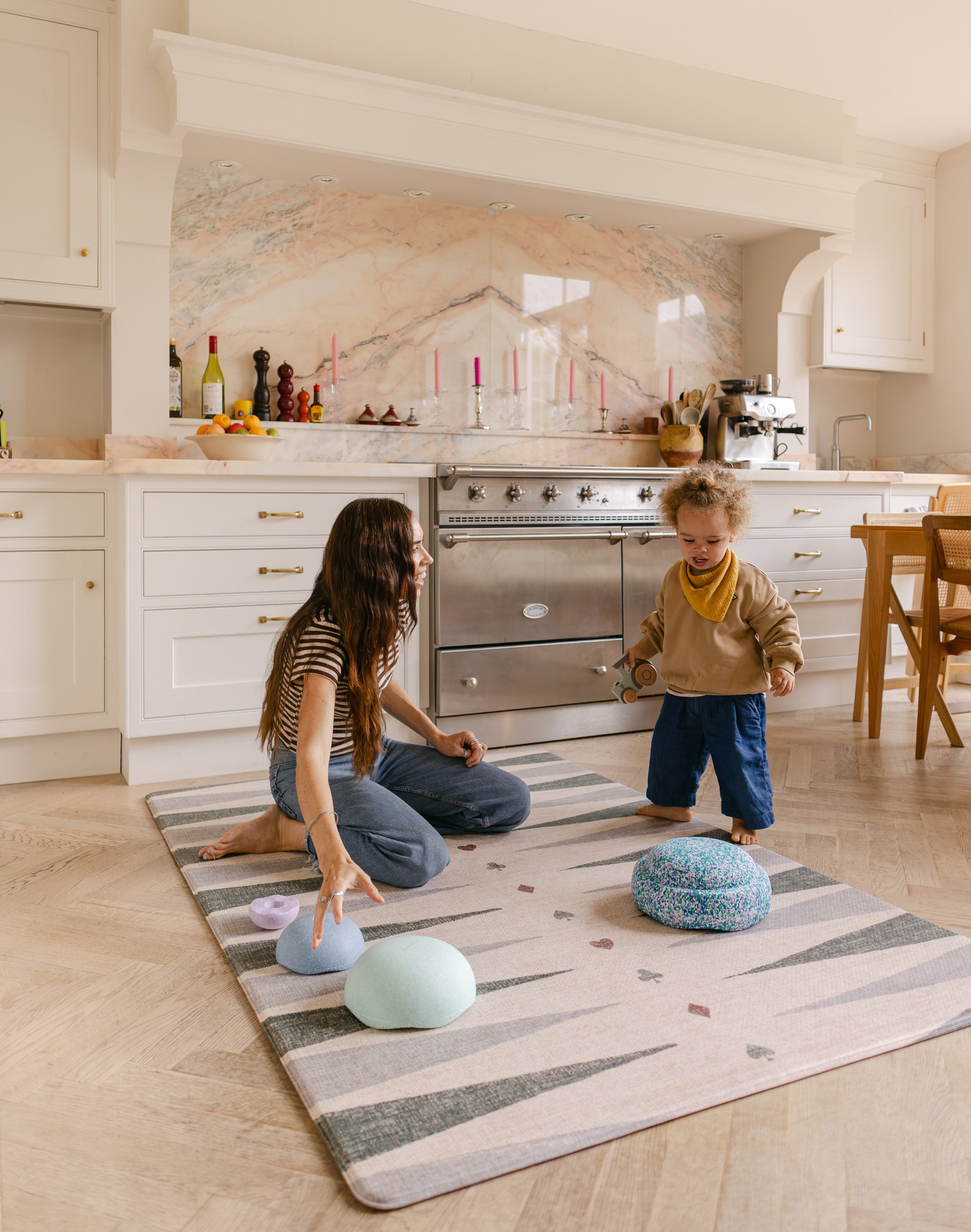 Mum and toddler playing balancing on The Counter, Totter + Tumble wipeable and reversible memory foam playmat