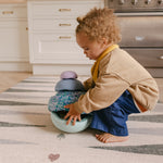 Toddler stacking on The Counter, Totter + Tumble wipeable and reversible memory foam playmat