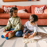 Children playing on The Counter, Totter + Tumble wipeable and reversible memory foam playmat