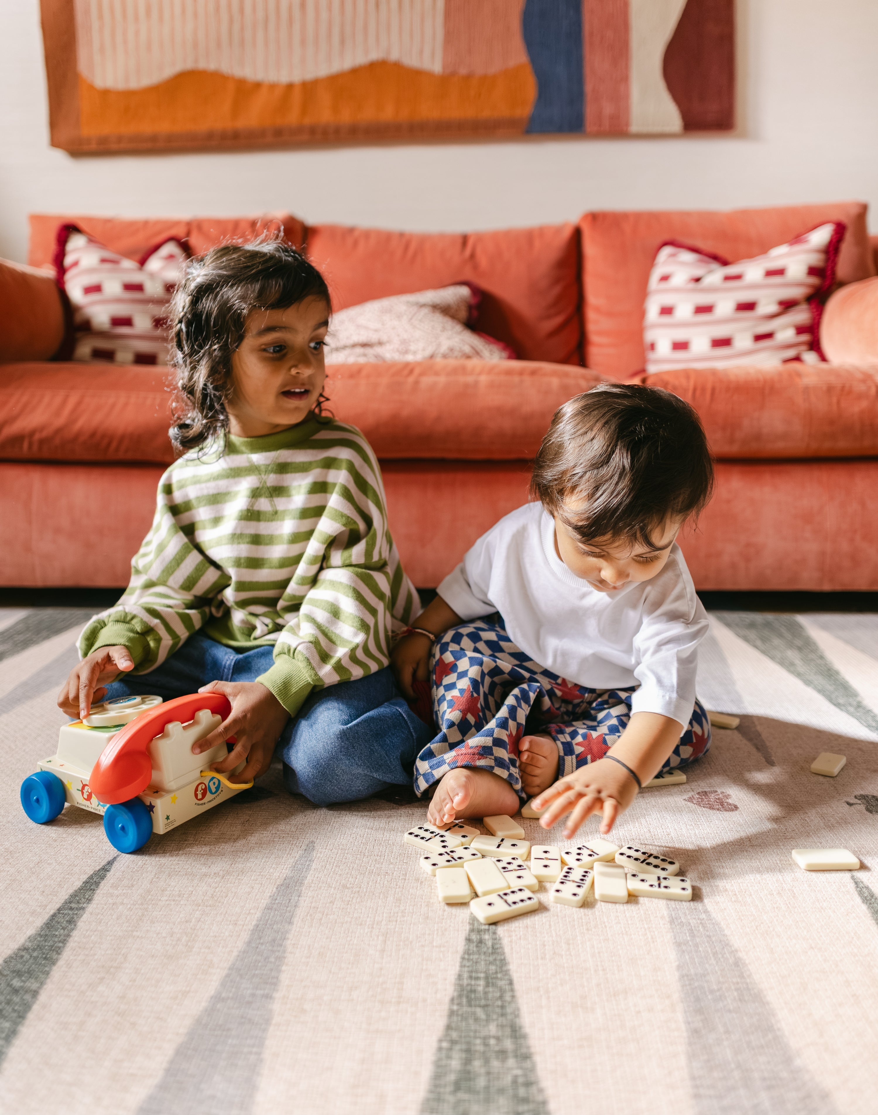 Children playing on The Counter, Totter + Tumble wipeable and reversible memory foam playmat