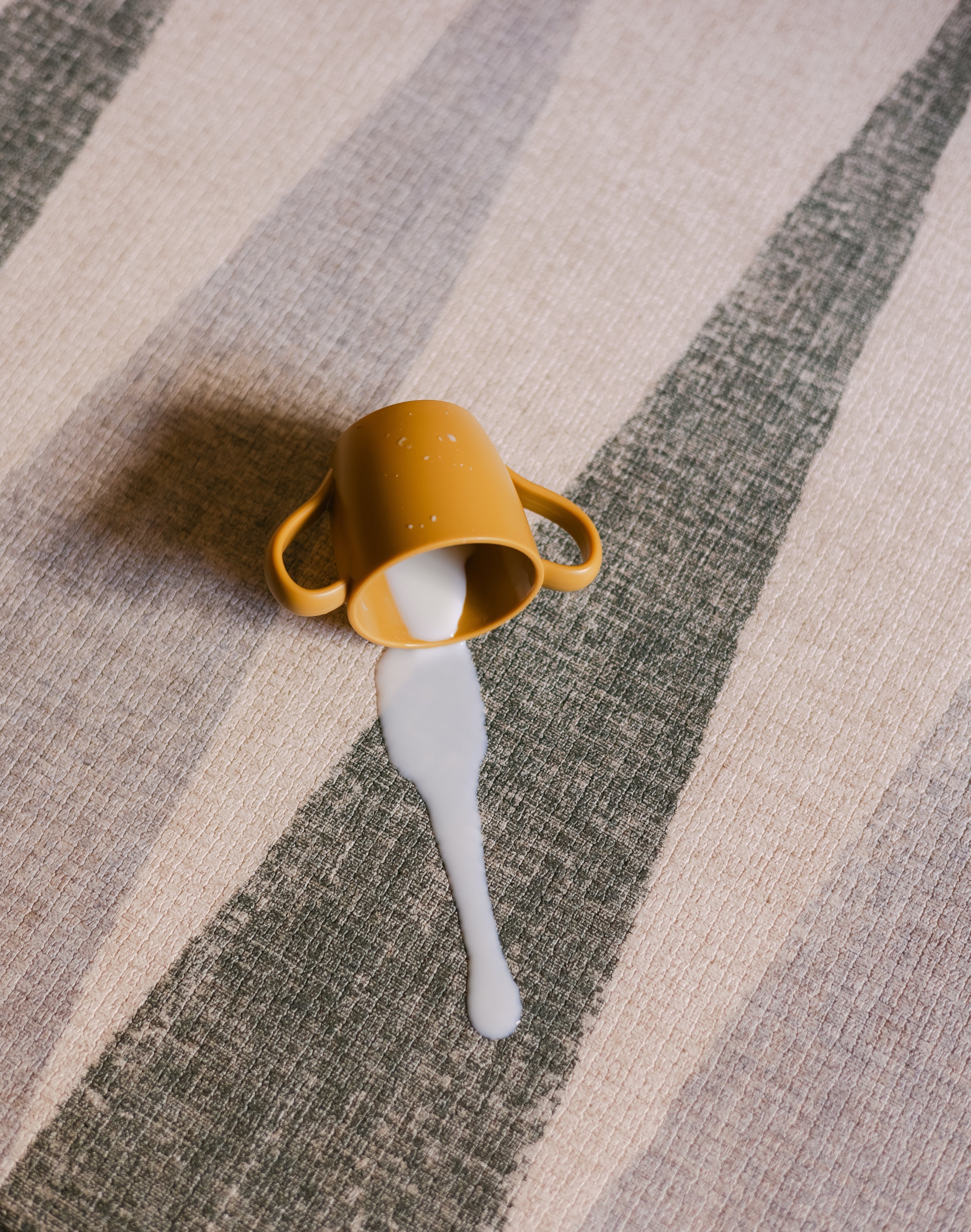 Milk spill on The Counter, Totter + Tumble wipeable and reversible memory foam playmat