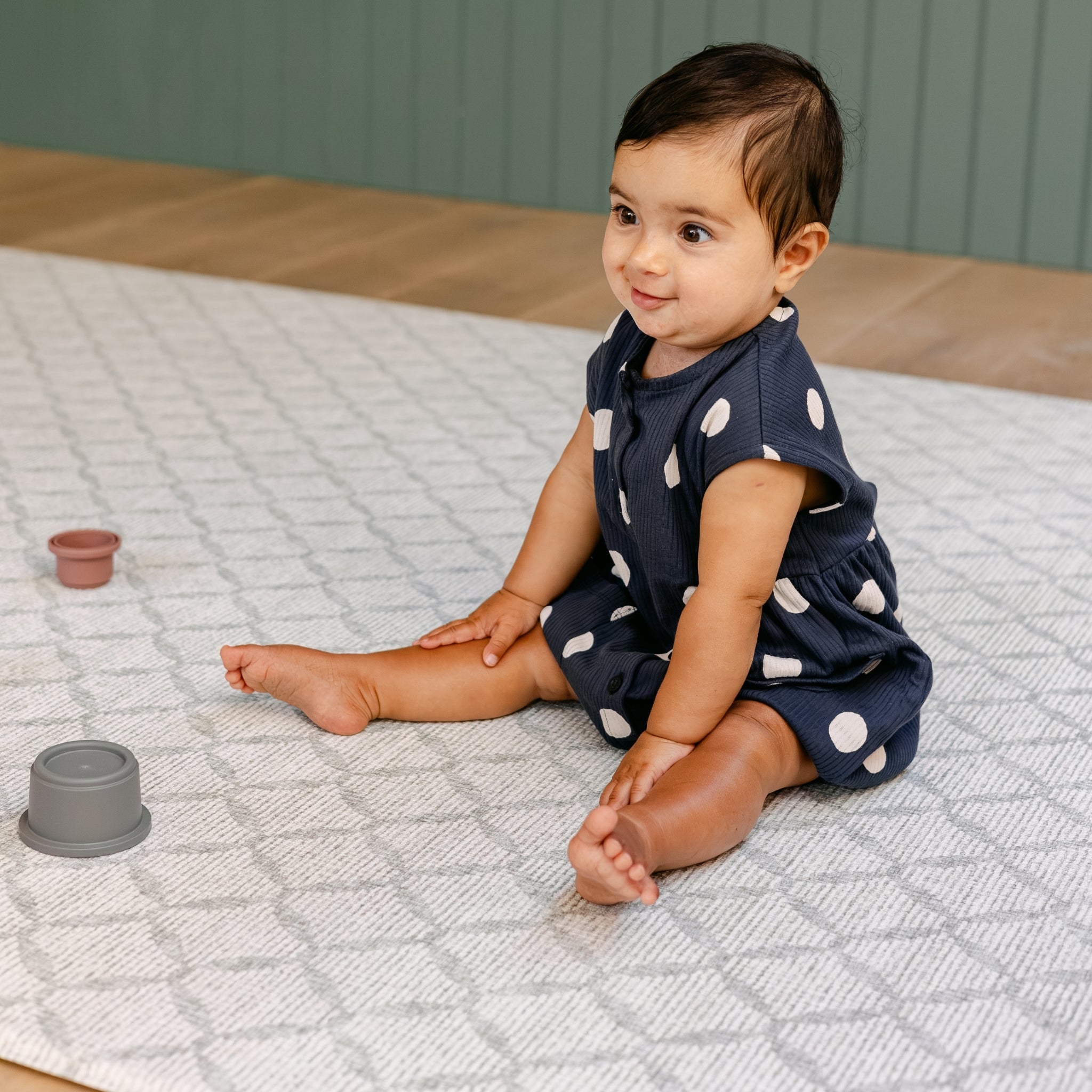 A baby sitting on the new coastal inspired The Gatherer playmat from totter and tumble
