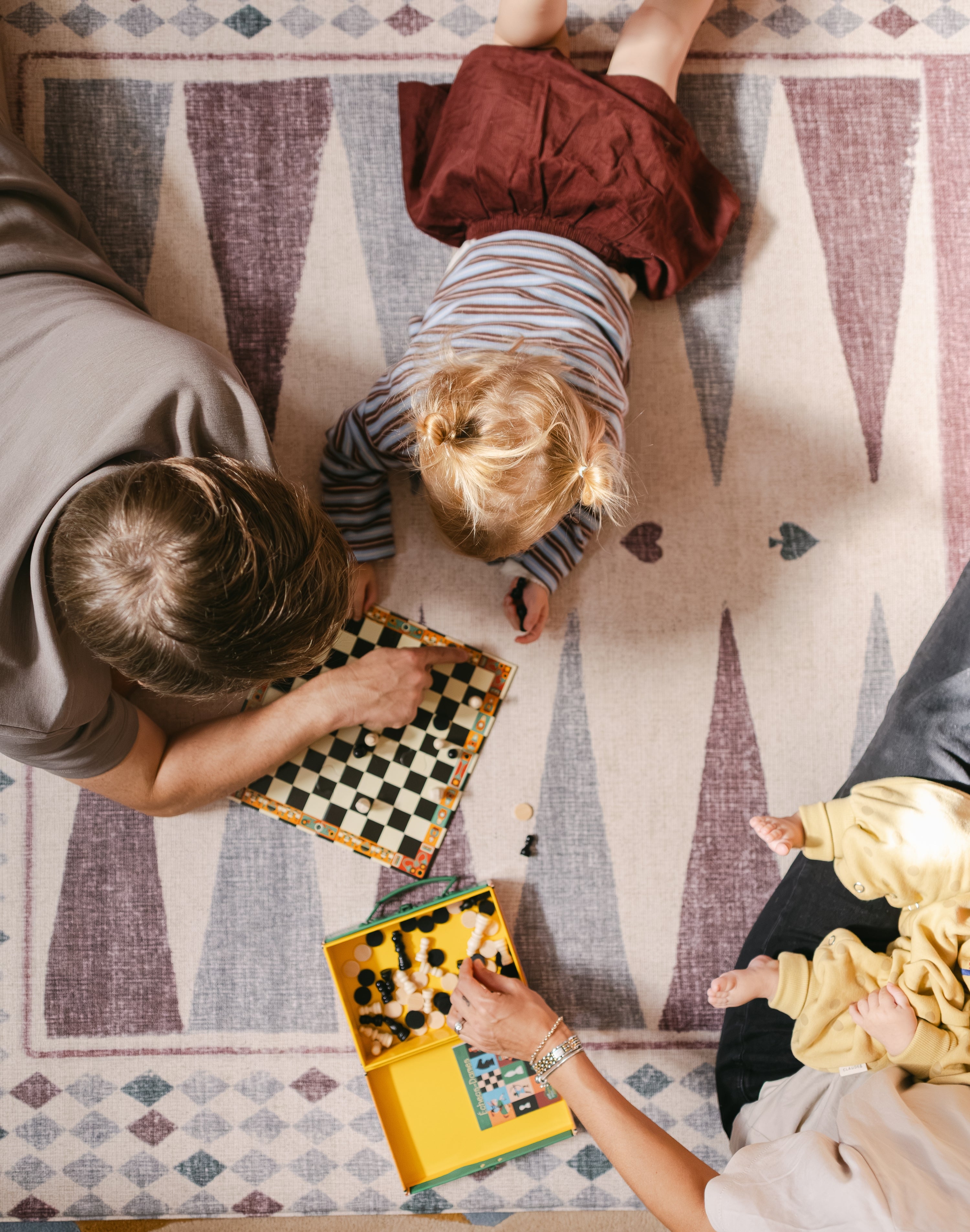 Aerial view of a family playing on The Roller Playmat by Totter + Tumble, the biggest one piece playmat on the market