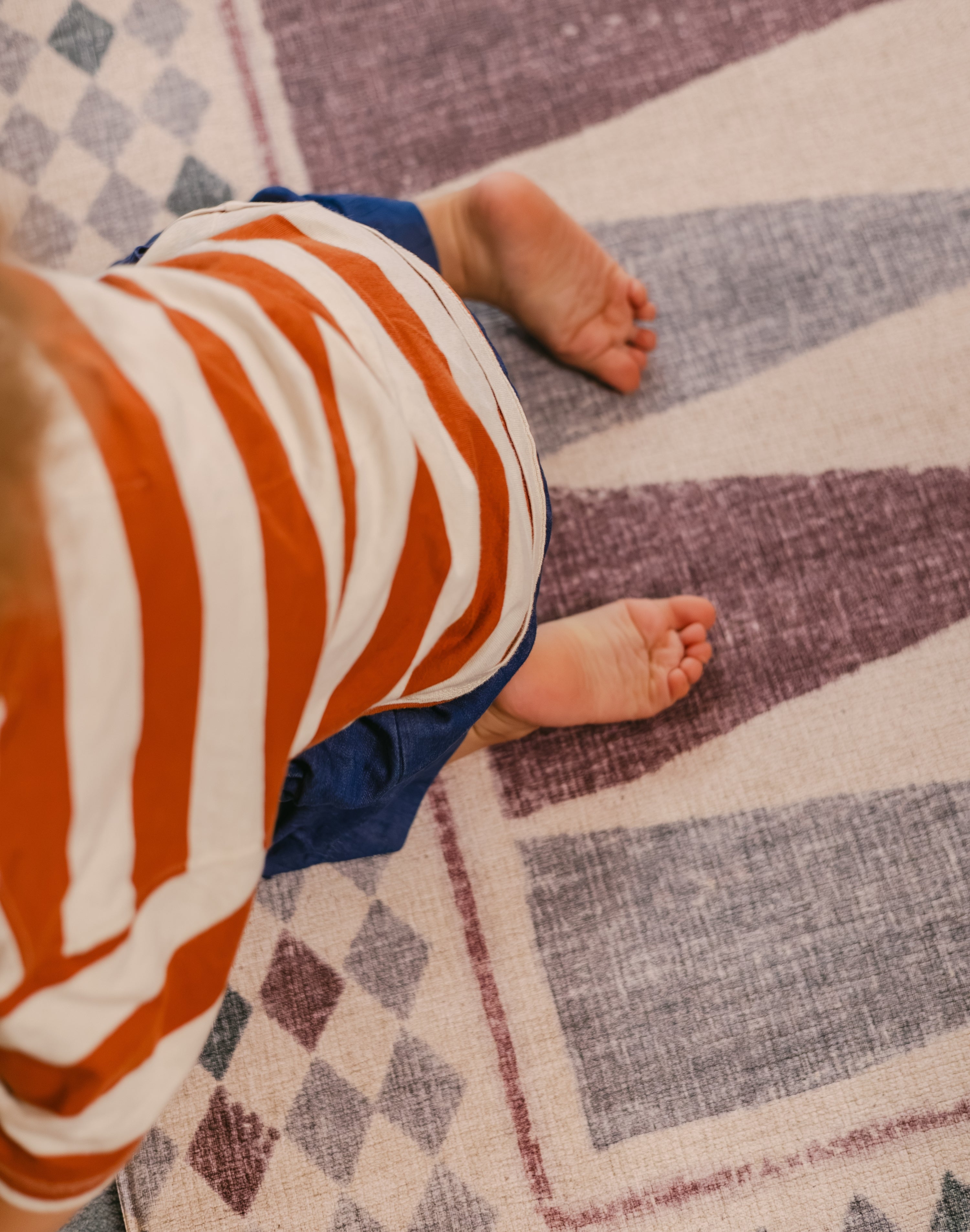 Child's toes on The Roller memory foam Playmat by Totter + Tumble, the biggest one piece playmat on the market