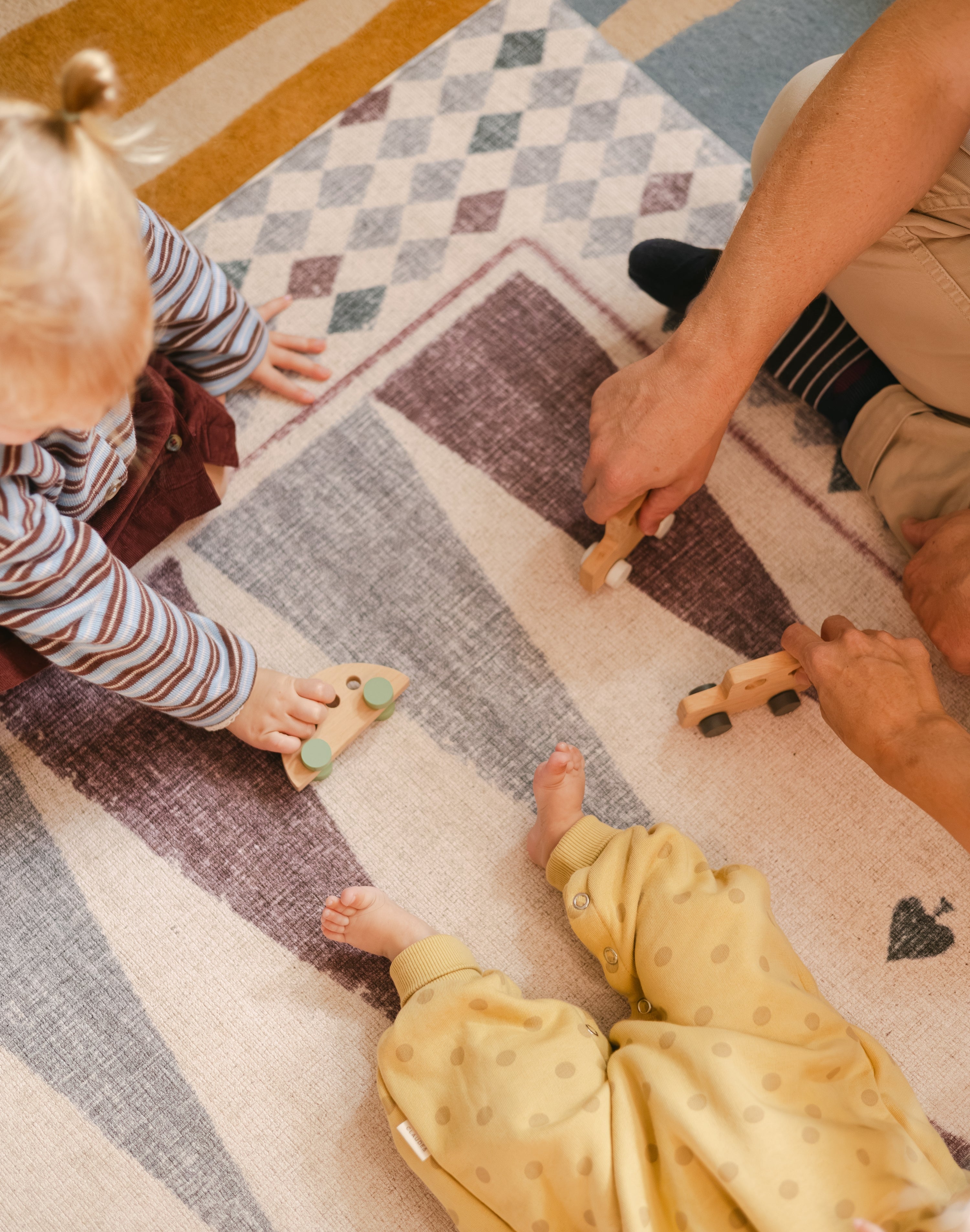 Children playing on The Roller Playmat by Totter + Tumble, the biggest one piece playmat on the market, reversible memory foam