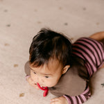 Tummy time on The Wildcard Totter + Tumble reversible wipeable memory foam playmat