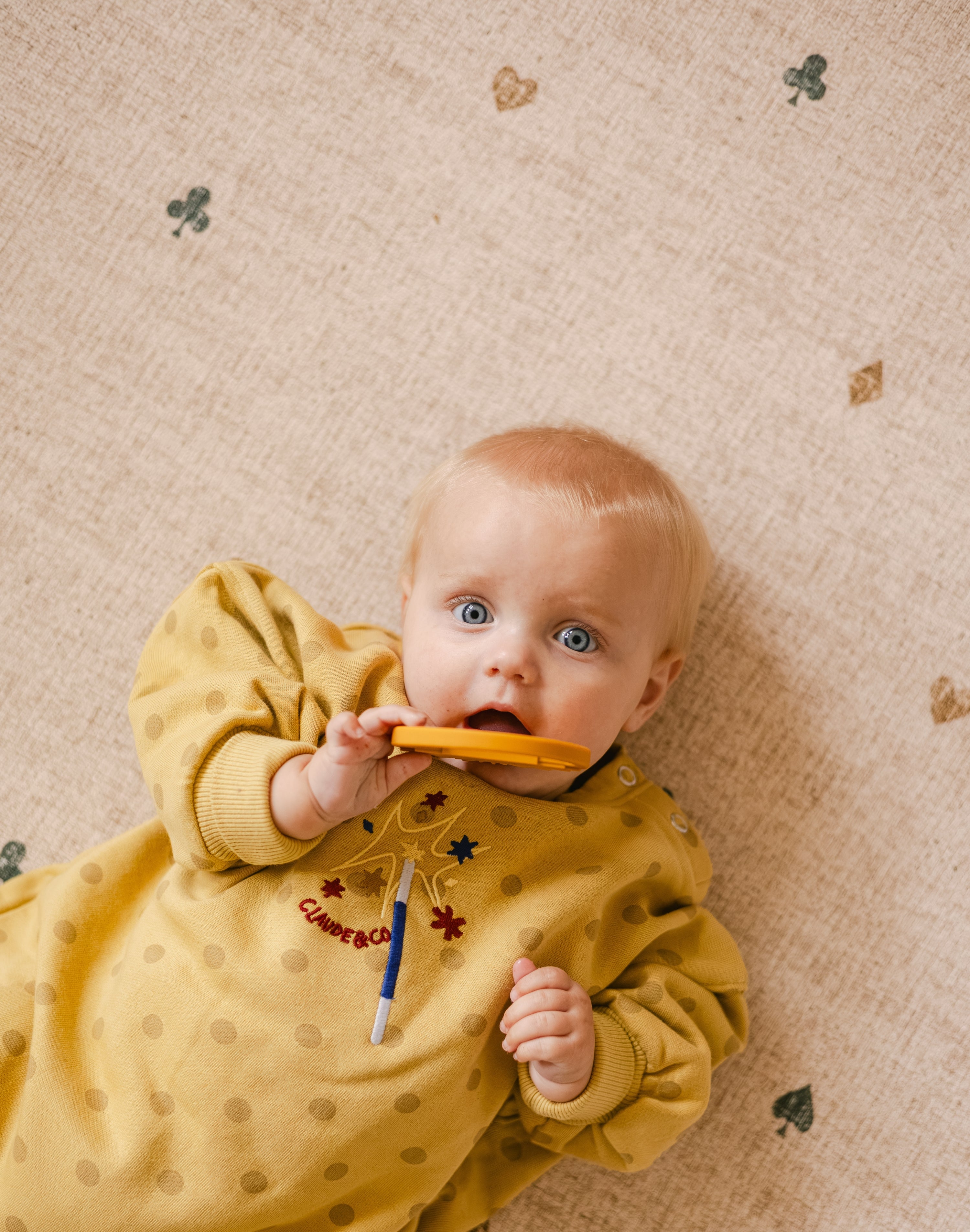 Baby lying on The Wildcard Totter + Tumble reversible wipeable memory foam playmat