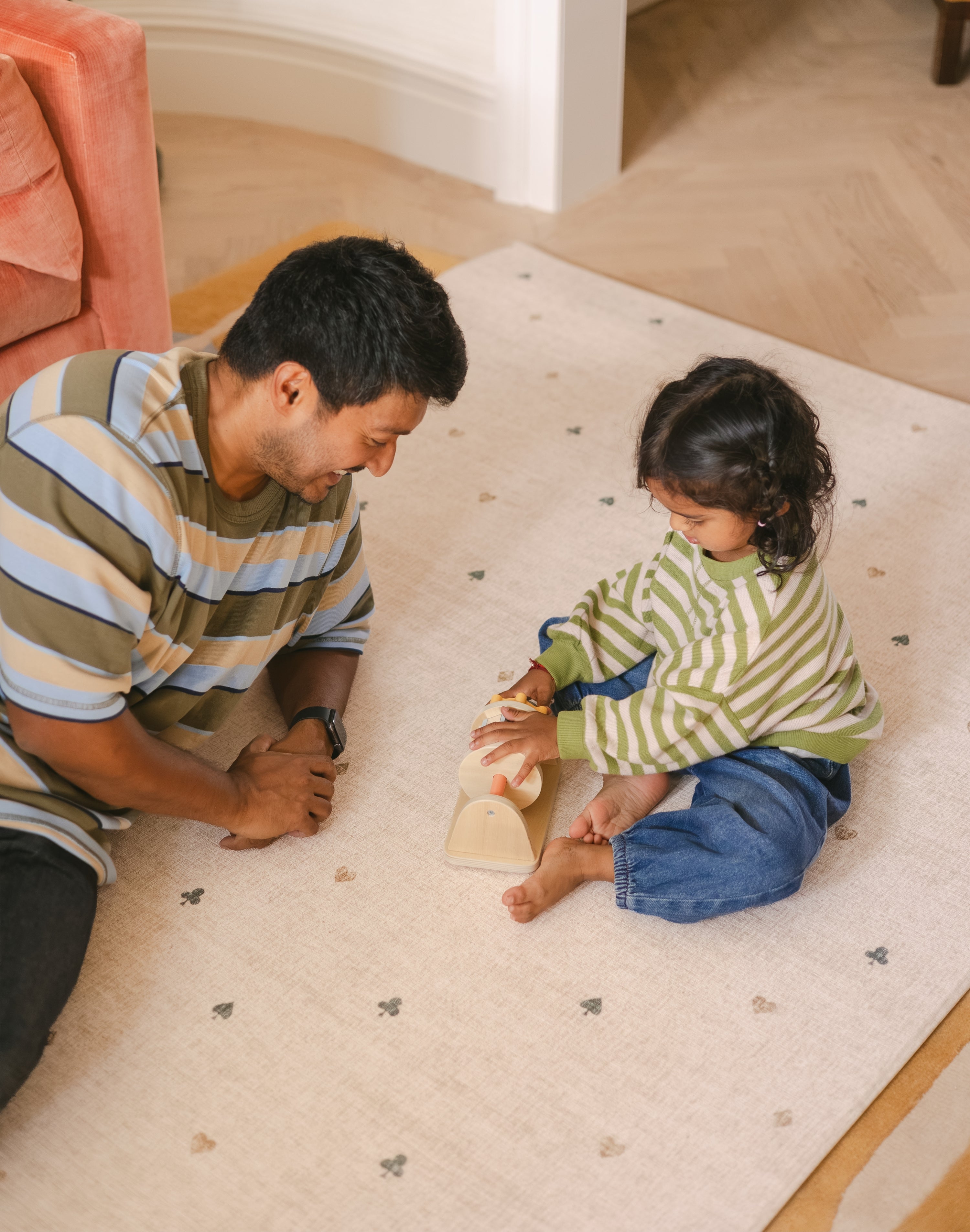 Dad and daughter playing on The Wildcard Totter + Tumble reversible wipeable memory foam playmat